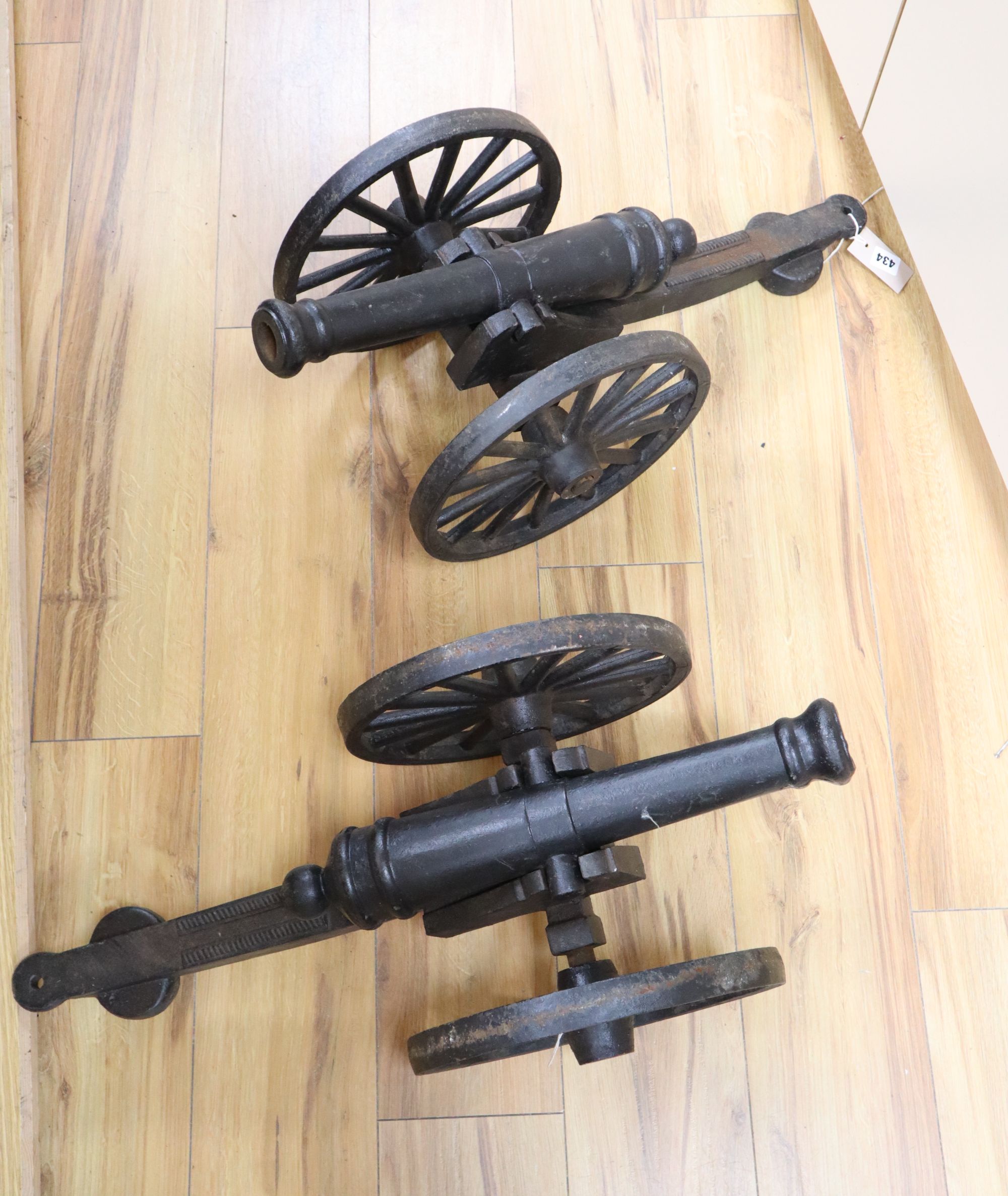 A pair of cast iron models of cannons, length 71cm